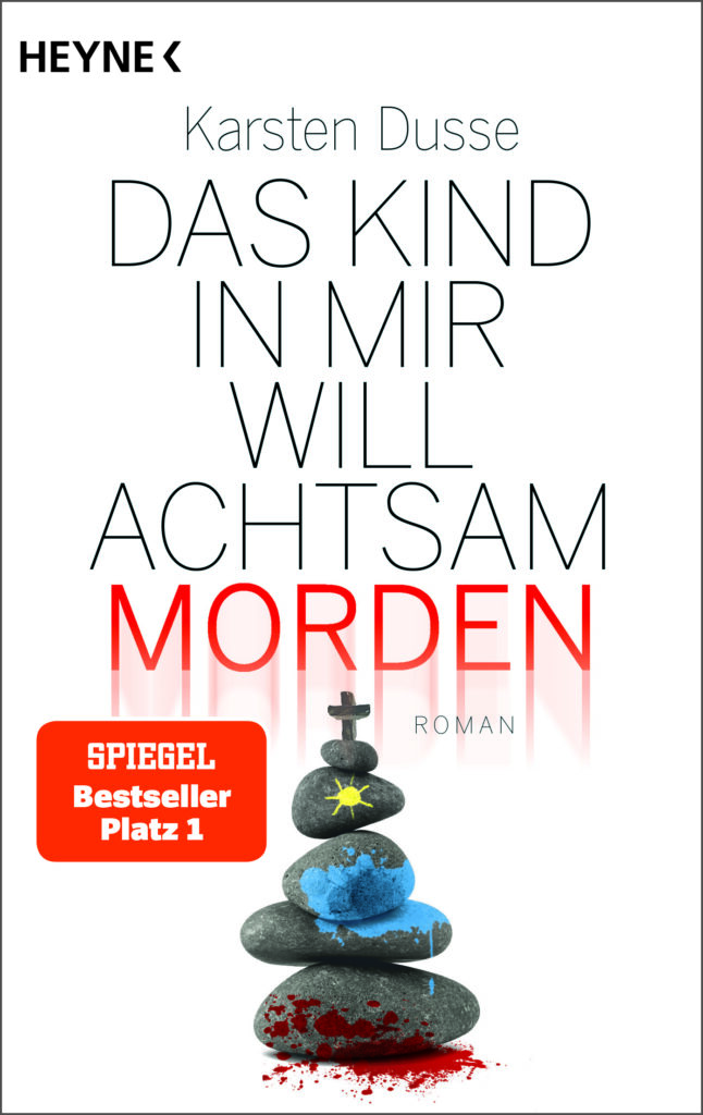 Buchcover. Oben der Text: Heyne. Kasten Dusse. Das Kind in mir will achtsam morden. Roman. Spiegel Bestseller Platz 1. Darunter mehrere graue, flache Steine übereinandergestapelt. Am unteren ist Blut. Auf zwei mittleren Steinen ist blaue Farbe. Auf eine der oberen Steine ist eine gelbe Sonne gemalt. Auf dem obersten Stein ist ein kleines Kreuz.