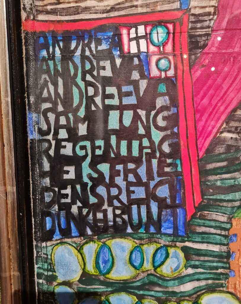 Der Teil des Bildes mit den Buchstaben aus der Nähe fotografiert. Sie sind dicht zusammen, so dass sie schwer zu lesen sind. Das oberste Wort heißt aber "Andrea". Weitere Wörter sind zum Beispiel "REgentag" und "Dunkelbunt".